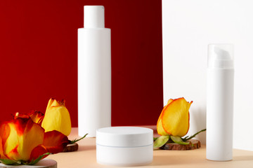 Cosmetic bottles with rose petals, copy space