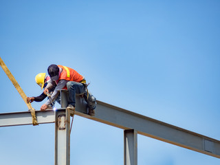 Builder welding on high-rise steel frame