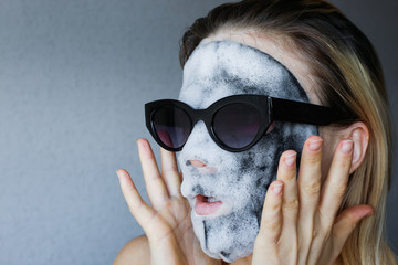 Face mask bubble foam facial  woman at beauty spa. Scary chemicals in beauty products. Black...