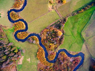 Meander of Goldapa river flowing in the vicinity of Banie Mazurskie during autumn season, Mazury, Poland