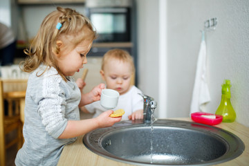 Children wash their hands in the sink