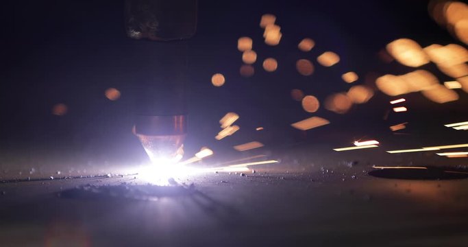Plasma cutting of metal with a cnc. A plasma cutter cuts a workpiece from a sheet of metal. Laser cutter in production. Industrial metal cutting by plasma laser. 4K video. High definition video