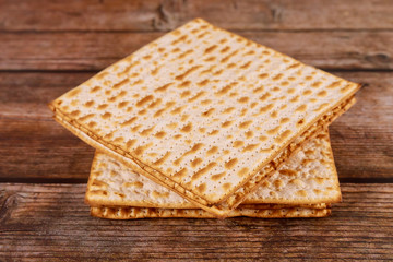 Jewish matzah bread on wooden background. Passover holiday concept