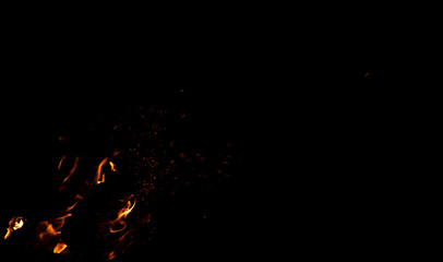 fire flame sparkles and orange illumination in black empty background night space for copy or text here wallpaper pattern concept photography