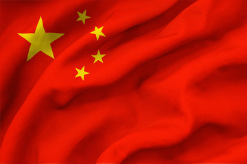 China national flag waving in the wind. Closeup of red silk standard of Republic of China with yellow stars. The People's Republic of China colors background.