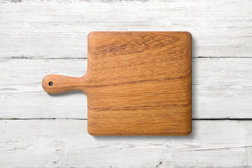 Mockup of wooden cutting board isolated on white wooden background, high resolution.