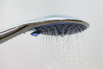 Naklejka na ściany i meble Shower head with flowing water.