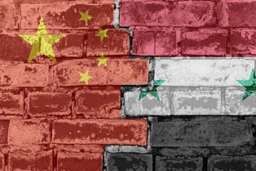 Chinese and Syrian flag against brick wall