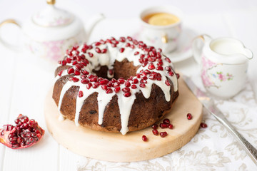 chocolate cake with pomegranate on a white table, a cozy breakfast, English tea party, chocolate dessert, a delicious cake with pomegranate, a photo of sweet food with free space for text