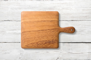 Mockup of wooden cutting board isolated on white wooden background, high resolution.