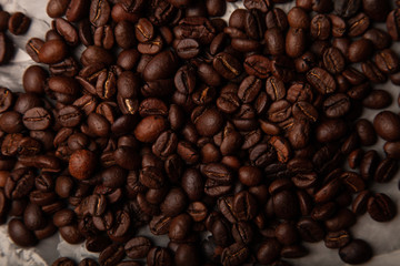 Composition with a coffee beans on a textured plastered background with a variety of arbitrary stains