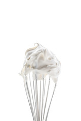 A close up of a slender whisk topped with whip cream peaks isolated against a bright white...