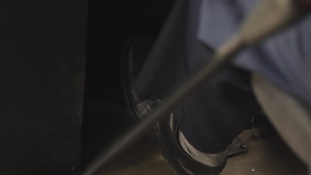Slow motion: a bus driver step on car pedal to accceleration the car.