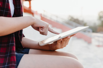 Hand of young girl using tablet