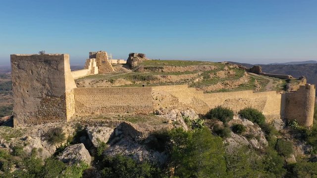 Aerial view of Cervera del Maestre castle with ruined excavated inner building remains surrounded by a partially restored outer wall of Arab origin
