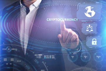 Business, Technology, Internet and network concept. Young businessman working on a virtual screen of the future and sees the inscription: Cryptocurrency