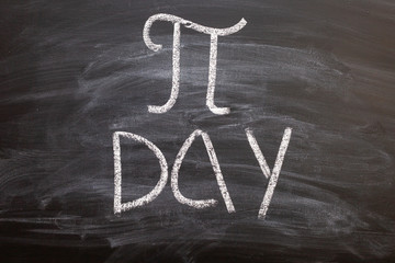 The symbol of number PI day written chalk on a blackboard