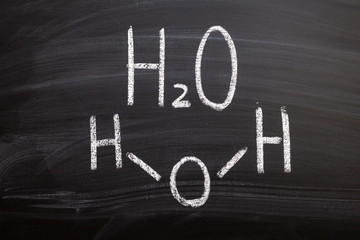 Water element chemical formula on chalkboard
