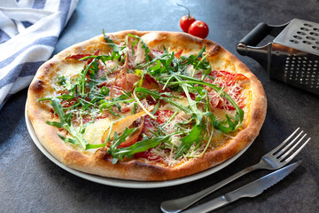 Green pizza toppings and cherry tomatoes waiting