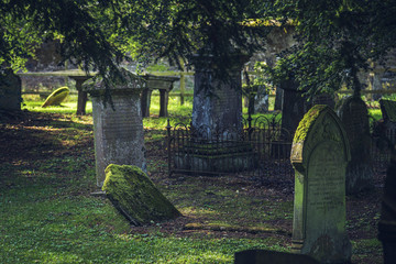 The summer view of cemetery with old gravestones in Scotland