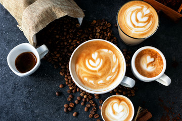 Espresso and coffee cups with coffee beans in background