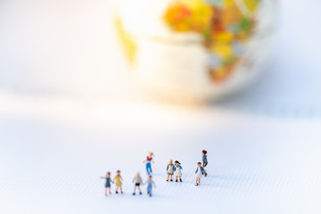 Miniature people: Group of children or family with globe word map using as background international family day concept. 