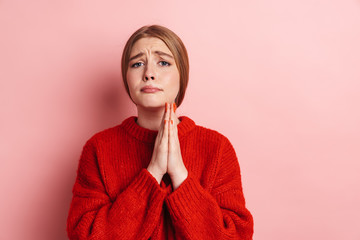 Photo of unhappy nice woman praying and holding palms together