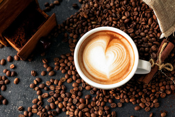 Pour latte art decorating a cup of espresso