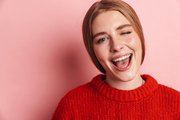 Photo of happy woman smiling and winking while posing