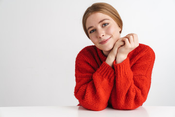 Photo of happy beautiful woman smiling while sitting at table