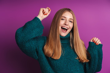 Photo of cheerful caucasian woman in green sweater smiling and dancing