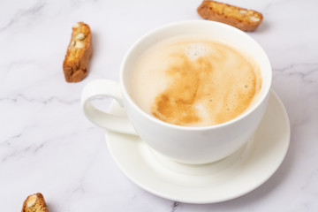 cup of coffee and cookies with nuts on a white background