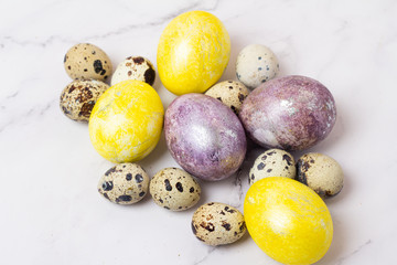different-colored chicken and quail eggs for Easter close-up