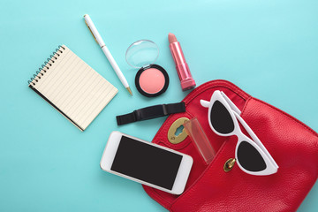 Woman fashion bag with cosmetic, accessories and smartphone