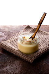 Vanilla custard with homemade cookie on wooden table. Top view. Copyspace