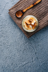 Tasty vanilla pudding on blue wooden background.