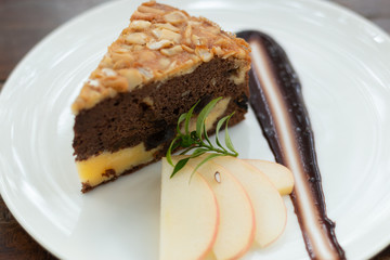 Pieces of nut cake with apple on white plate, bakery and food.