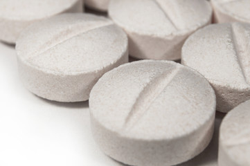 White medical pills and tablets with bottle