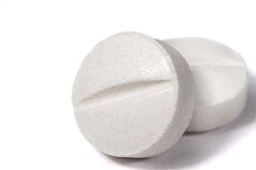 White medical pills and tablets with bottle