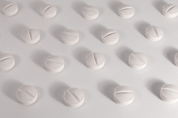 White medical pills and tablets with bottle