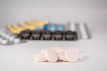 White medical pills and tablets with bottle