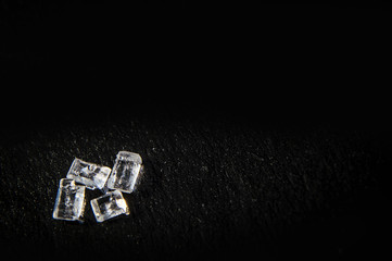 White sugar crystals on a black background