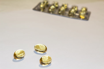 capsules of fish oil lie on a hand on a light background. view from above. vitamins for health.