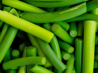 Sliced garlic sticks are very tender and delicious. They are also known as garlic spears , stems , or tops .