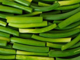Sliced garlic sticks are very tender and delicious. They are also known as garlic spears , stems , or tops .