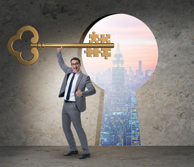Businessman with key and jigsaw puzzle pieces