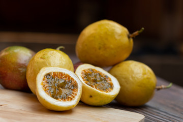 Thai Passion fruit isolated slice on wooden plate.