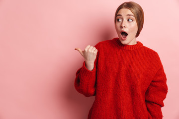 Photo of shocked woman expressing surprise and pointing finger aside