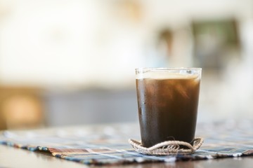 A glass of ice americano coffee in cafe