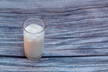 Ice milk on the wooden background.